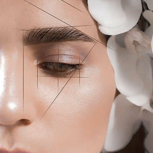 Close-up of a face with geometric lines mapping eyebrow shape, framed by white orchids.
